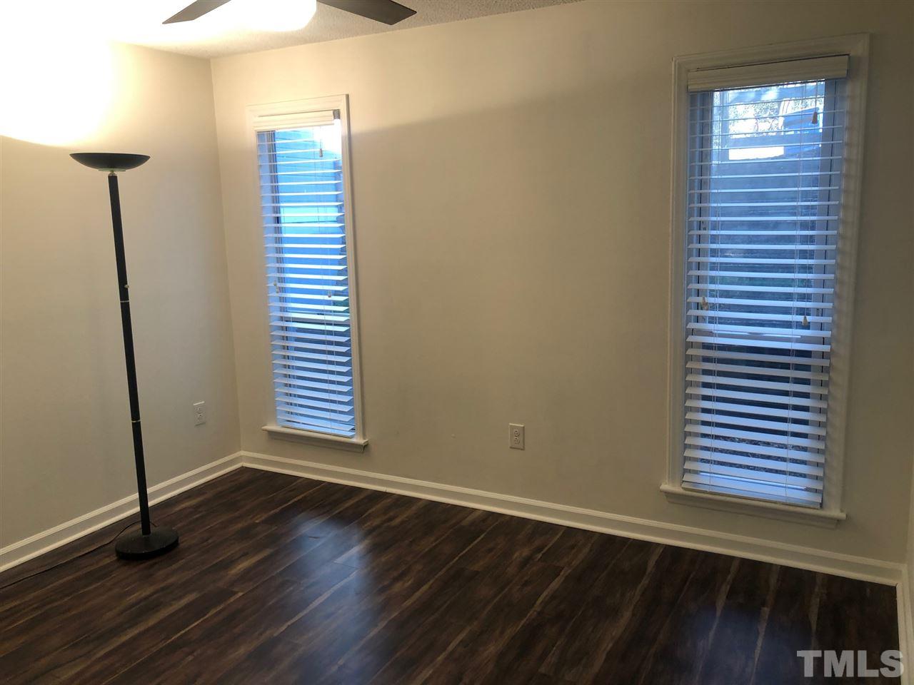 4621 Timbermill Court, Unit 103 Raleigh, NC 27612 - Photo 12 of 13 a view of an empty room with wooden floor and a window