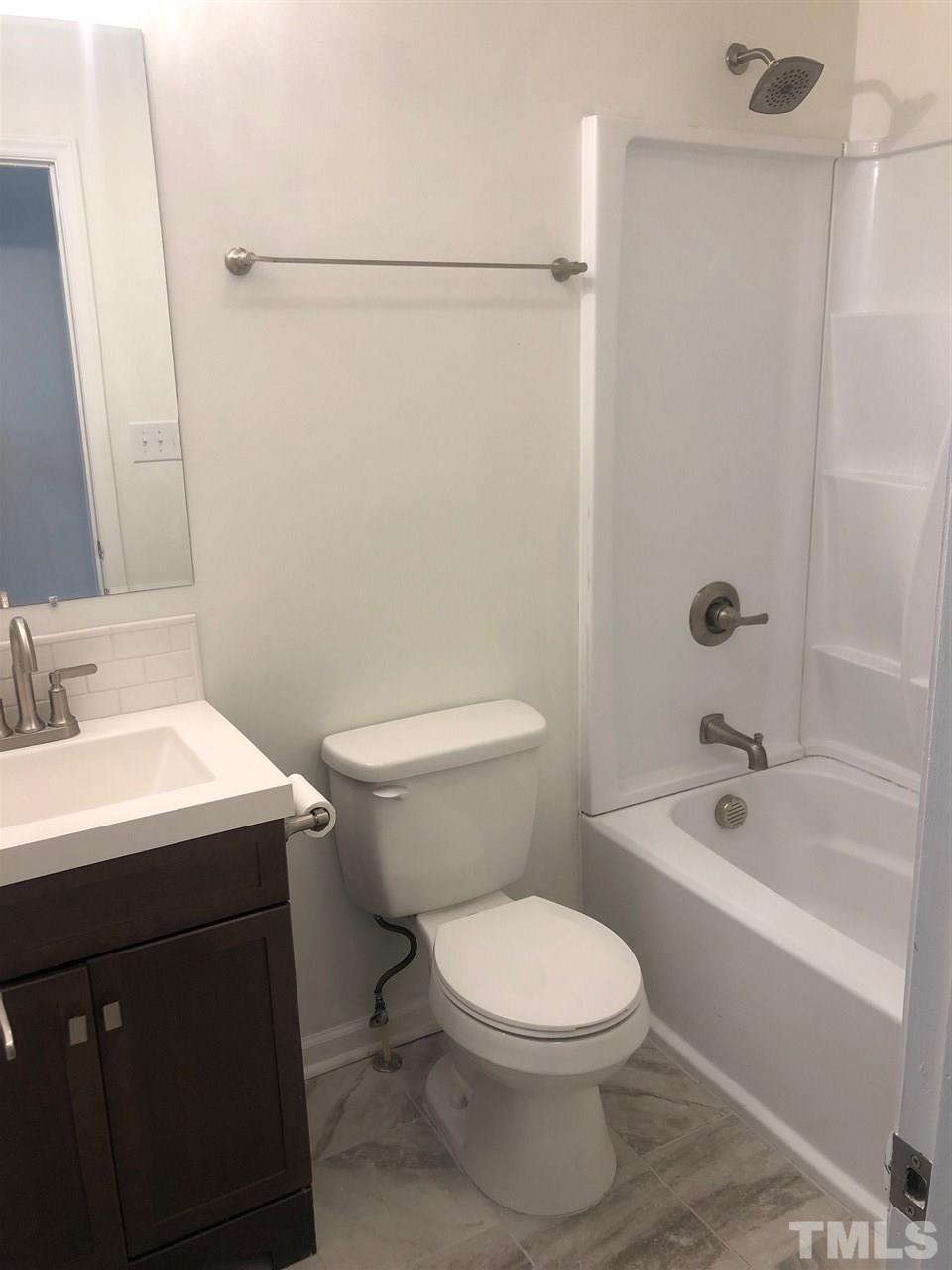 4621 Timbermill Court, Unit 103 Raleigh, NC 27612 - Photo 9 of 13 a bathroom with a sink a toilet and shower