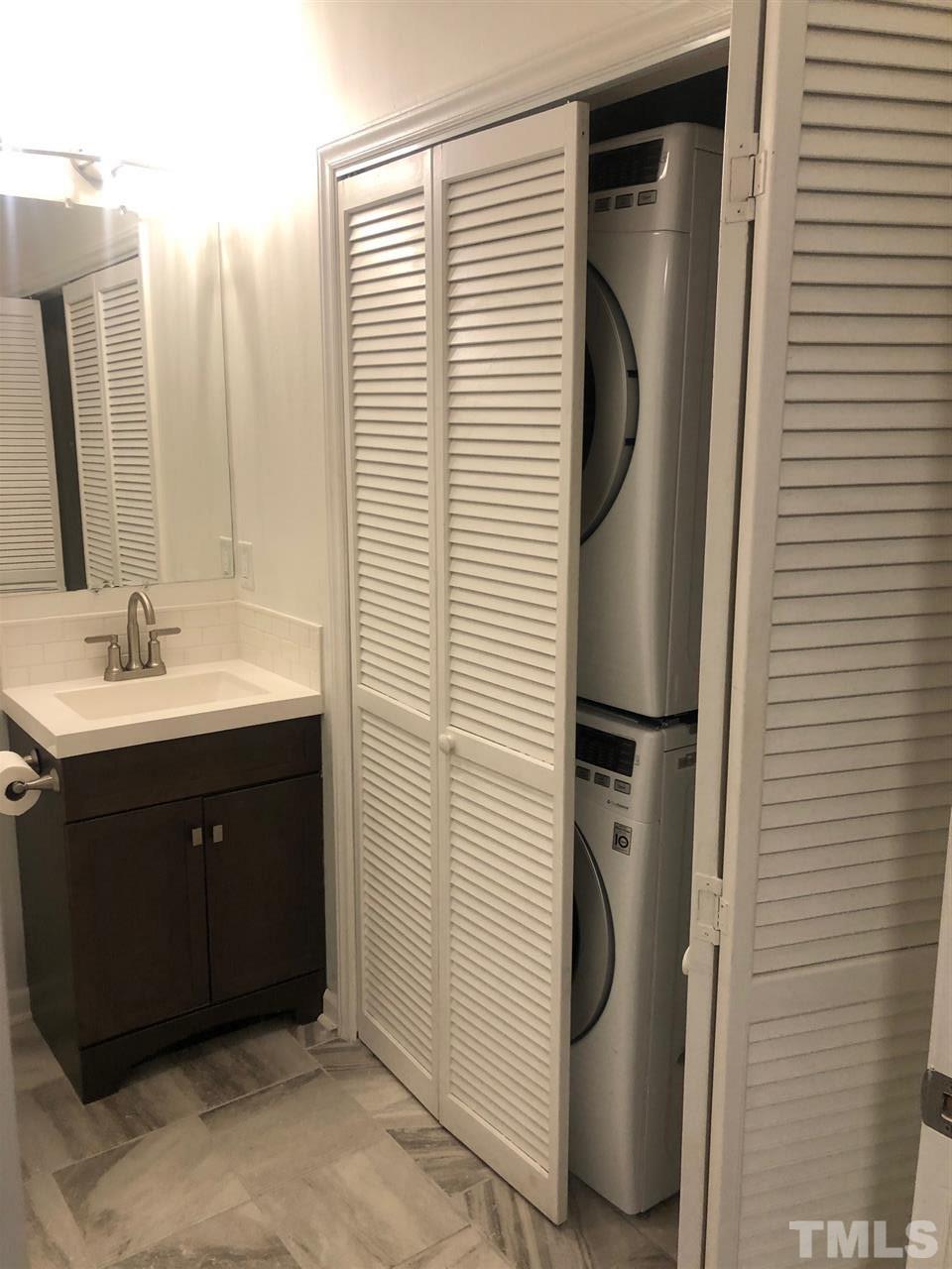 4621 Timbermill Court, Unit 103 Raleigh, NC 27612 - Photo 10 of 13 a bathroom with a sink a mirror and shower