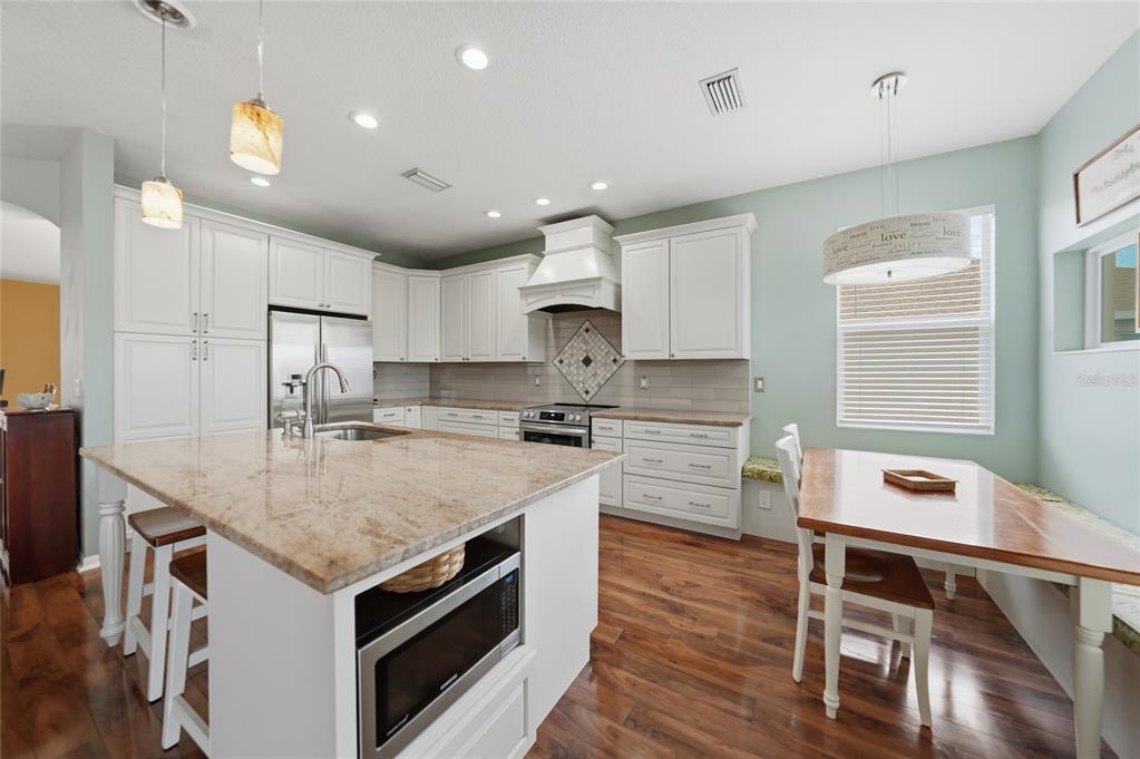 5221 Layton Drive Venice, FL 34293 - Photo 11 of 33 a kitchen with a stove a sink and a refrigerator