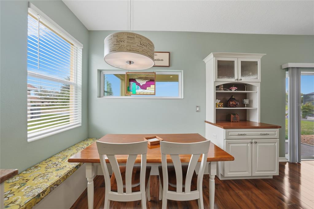 5221 Layton Drive Venice, FL 34293 - Photo 13 of 33 a view of a dining room with furniture wooden floor and chandelier