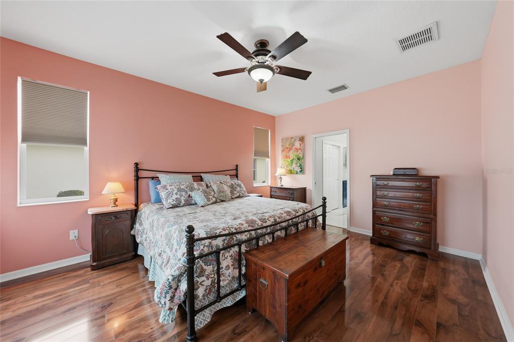 5221 Layton Drive Venice, FL 34293 - Photo 15 of 33 a bedroom with a bed and wooden floor