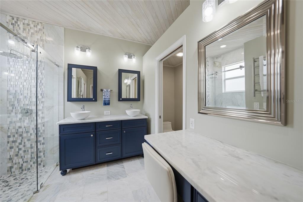 5221 Layton Drive Venice, FL 34293 - Photo 17 of 33 a bathroom with a granite countertop double vanity sink and mirror