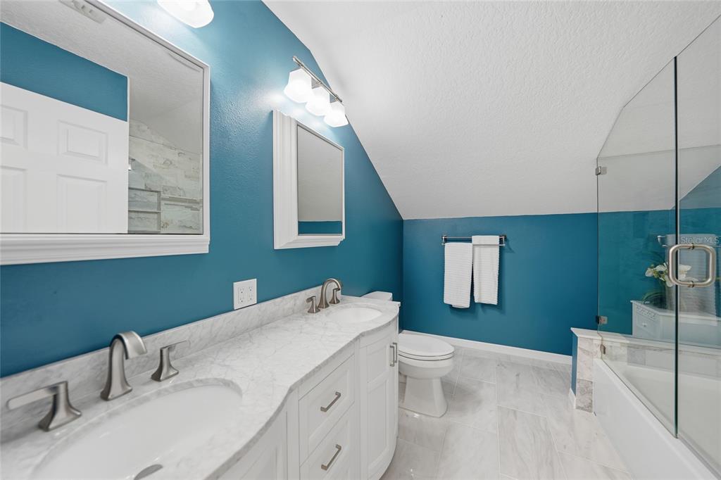 5221 Layton Drive Venice, FL 34293 - Photo 20 of 33 a bathroom with a granite countertop sink mirror and toilet