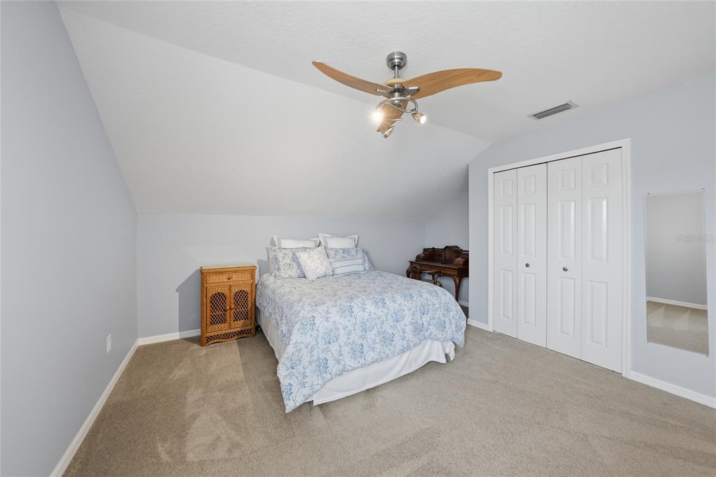 5221 Layton Drive Venice, FL 34293 - Photo 25 of 33 a bedroom with a bed and ceiling fan