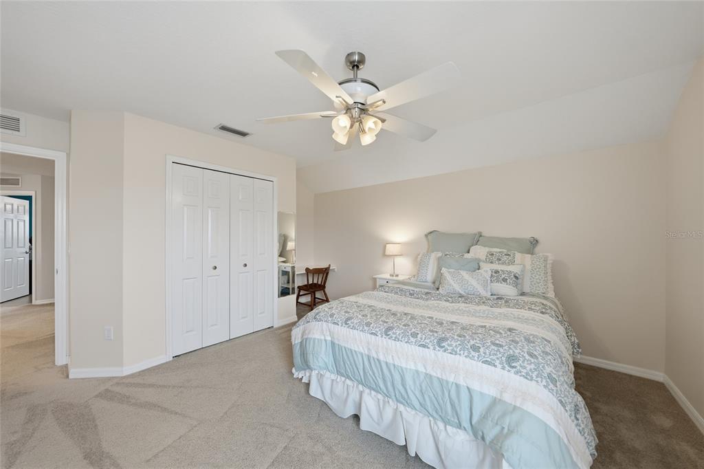 5221 Layton Drive Venice, FL 34293 - Photo 27 of 33 a bedroom with a bed and a chandelier