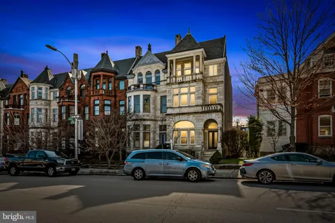 a view of a street that has couple of cars parked on the road