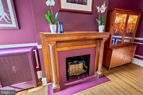 a view of a hallway with wooden floor and stairs