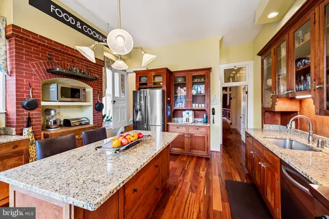 a view of a livingroom with wooden floor and stairs