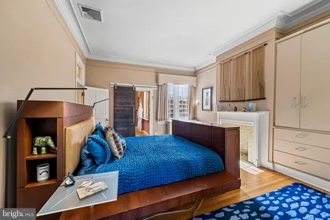 a bedroom with furniture window and wooden floor