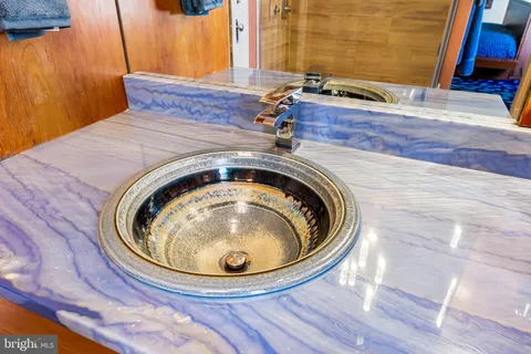 a view of a roof deck with table and chairs and wooden floor