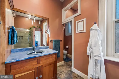a view of a chairs and table in the back yard of the house