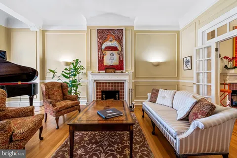 a dining room with furniture a fireplace and wooden floor