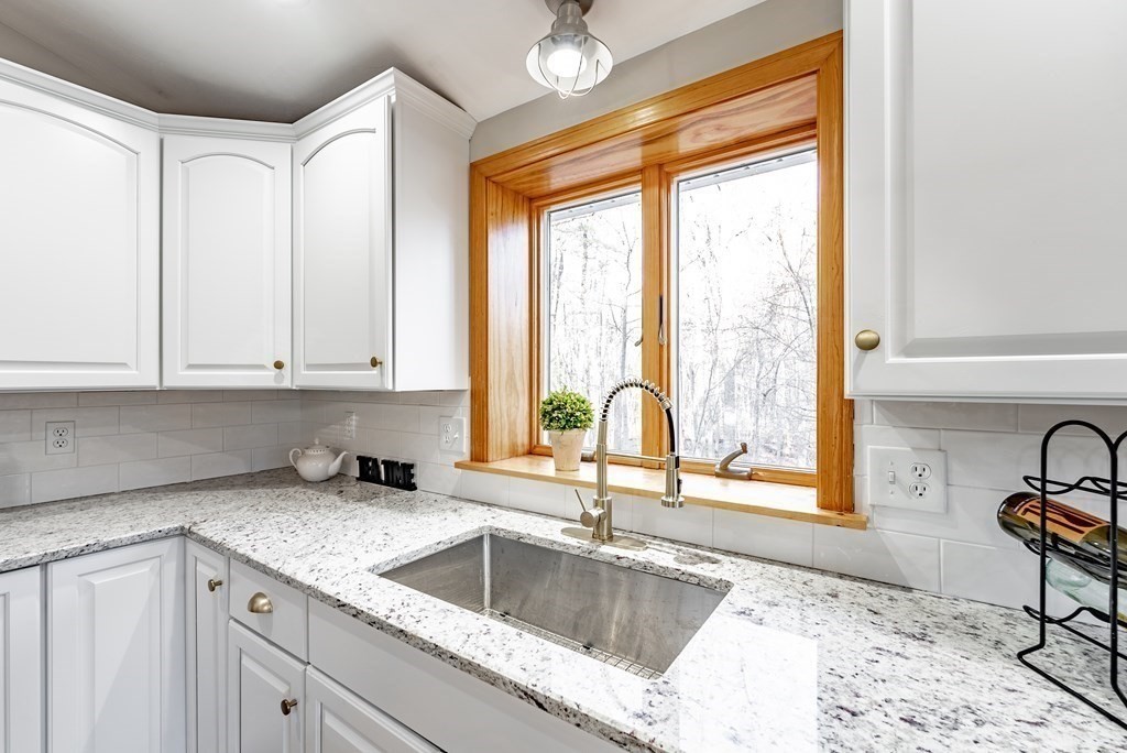 209 Freeman Road Charlton, MA 01507 - Photo 11 of 30 a kitchen with granite countertop a sink and a window