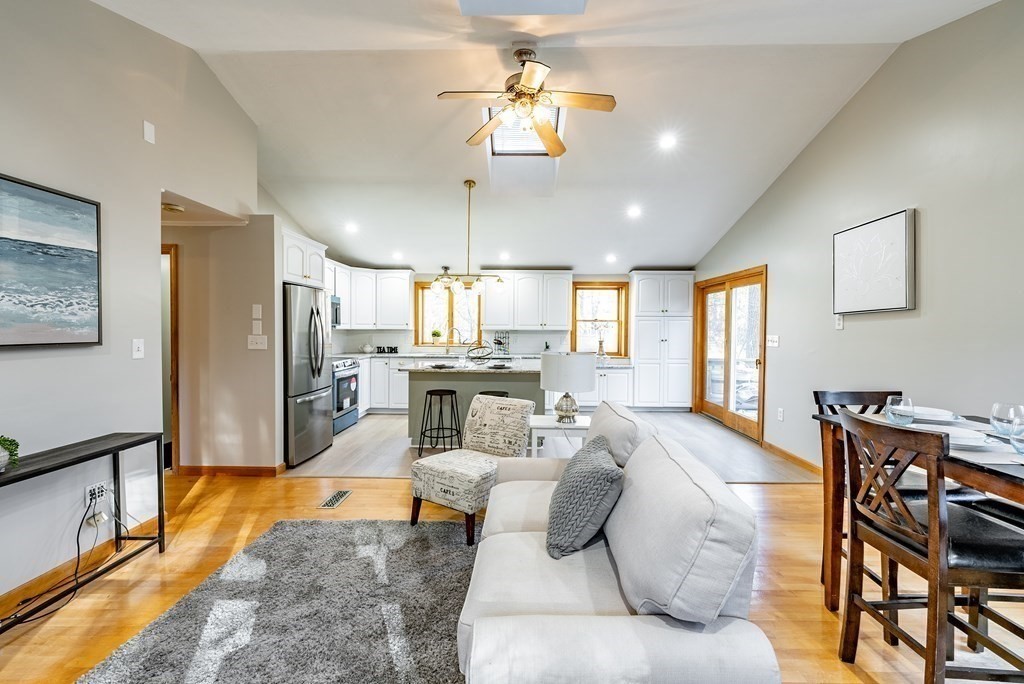 209 Freeman Road Charlton, MA 01507 - Photo 17 of 30 a living room with furniture a chandelier and a flat screen tv