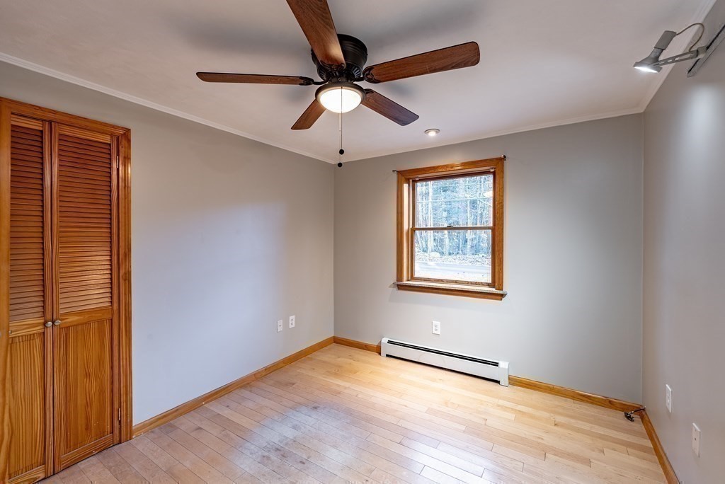 209 Freeman Road Charlton, MA 01507 - Photo 24 of 30 a view of an empty room with wooden floor and a window