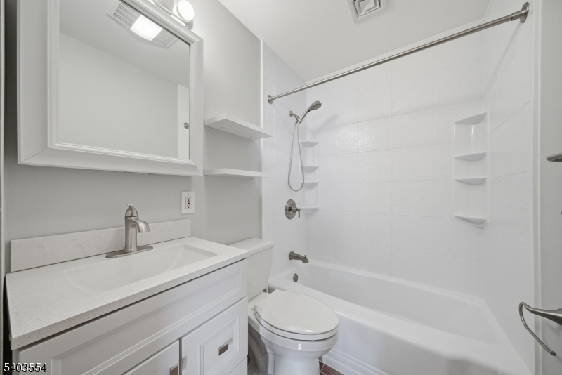 52 Broadway Clark, NJ 07066 - Photo 11 of 47 a bathroom with a sink a toilet and a bathtub