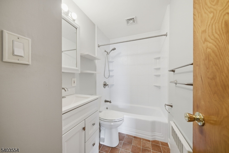 52 Broadway Clark, NJ 07066 - Photo 12 of 47 a bathroom with a shower toilet and sink