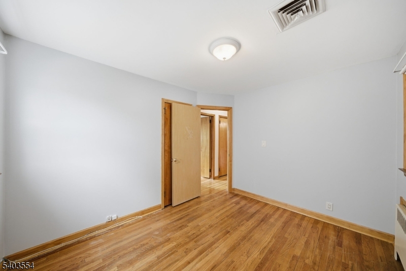 52 Broadway Clark, NJ 07066 - Photo 16 of 47 a view of an empty room with wooden floor