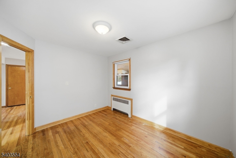 52 Broadway Clark, NJ 07066 - Photo 17 of 47 a view of a livingroom with wooden floor and a window