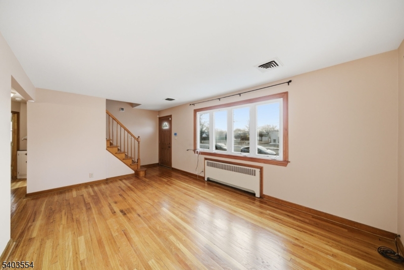 52 Broadway Clark, NJ 07066 - Photo 5 of 47 an empty room with wooden floor and windows