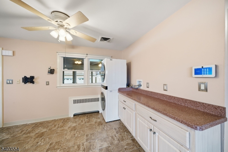 52 Broadway Clark, NJ 07066 - Photo 7 of 47 a spacious bathroom with a granite countertop sink and a mirror