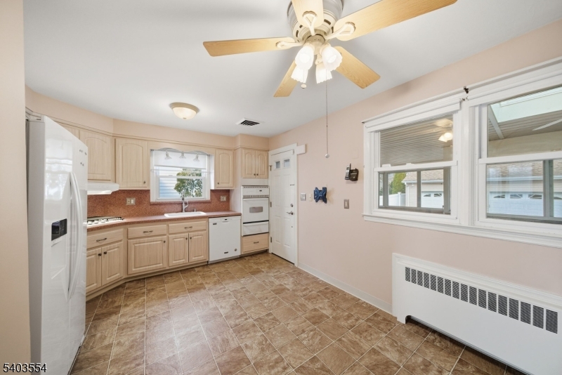 52 Broadway Clark, NJ 07066 - Photo 8 of 47 a kitchen with stainless steel appliances kitchen island granite countertop a refrigerator and a sink