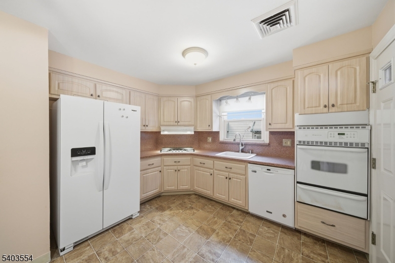 52 Broadway Clark, NJ 07066 - Photo 9 of 47 a kitchen with white cabinets and white appliances
