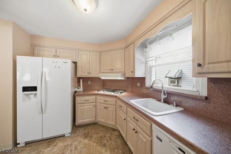 52 Broadway Clark, NJ 07066 - Photo 10 of 47 a kitchen with a sink a refrigerator and cabinets