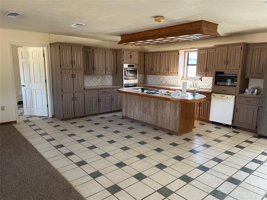 770 Rains County Road 3060 Emory, TX 75440 - Photo 29 of 39 a kitchen with stainless steel appliances a sink and cabinets