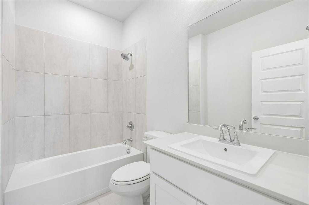 1469 Companero Street Haslet, TX 76052 - Photo 27 of 36 a bathroom with a sink a toilet and a bathtub