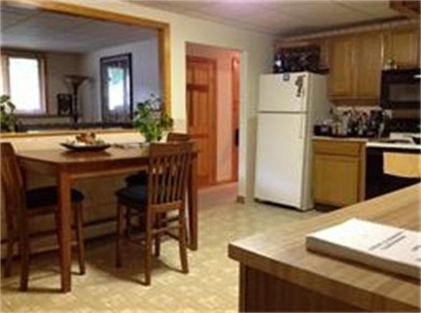 39 Ashmore Road Worcester, MA 01602 - Photo 18 of 24 a kitchen with refrigerator a table and chairs