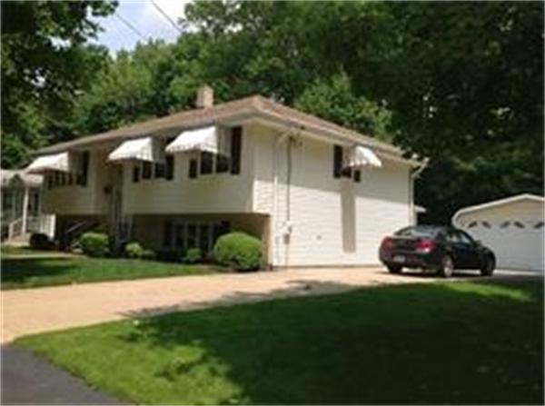 39 Ashmore Road Worcester, MA 01602 - Photo 2 of 24 a front view of a house with a garden and yard