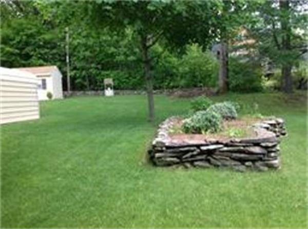 39 Ashmore Road Worcester, MA 01602 - Photo 5 of 24 a front view of a house with a yard table and chairs