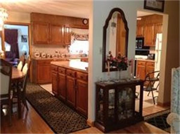 39 Ashmore Road Worcester, MA 01602 - Photo 8 of 24 a view of living room with kitchen island stainless steel appliances wooden floor and furniture