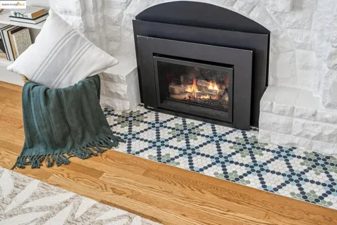 a living room with a fireplace and a flat screen tv