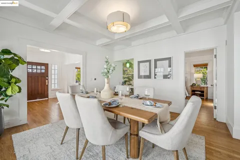 a view of a dining room with furniture wooden floor and a chandelier