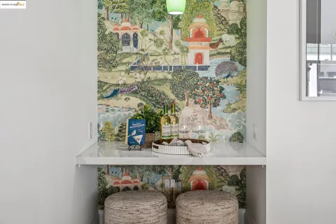 a kitchen with stainless steel appliances granite countertop a stove a refrigerator a sink a dining table and chairs with wooden floor