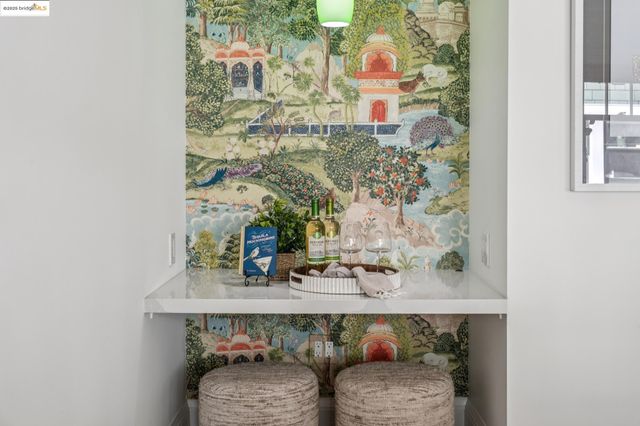 a kitchen with stainless steel appliances granite countertop a stove a refrigerator a sink a dining table and chairs with wooden floor