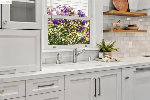 a large kitchen with stainless steel appliances granite countertop a large center island and a sink