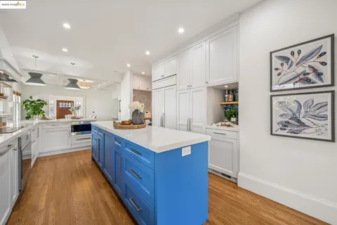 a kitchen with counter top space and wooden floor