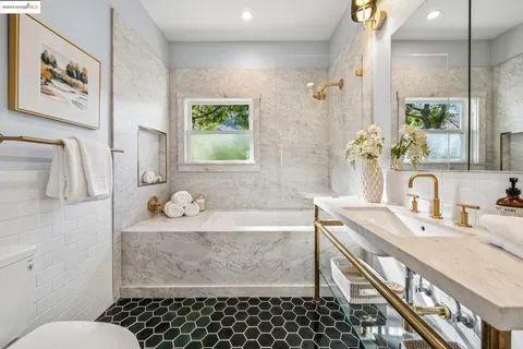 a bathroom with a granite countertop sink and a vanity