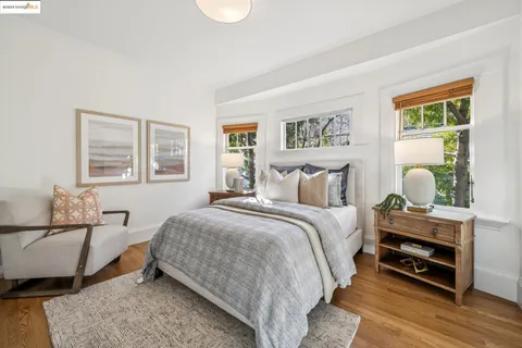 a bedroom with a bed and a painting on the wall