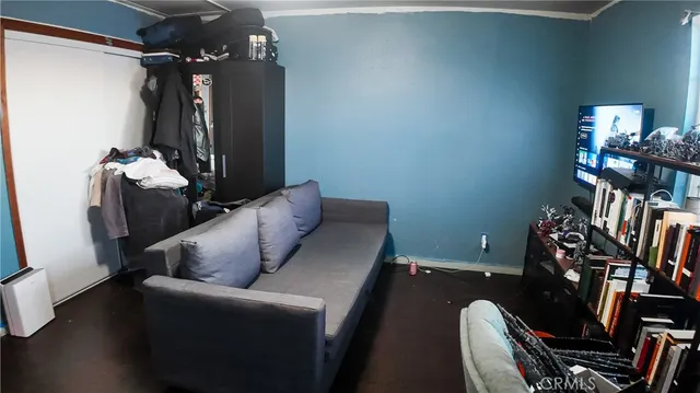 a view of a backyard with plants and large trees