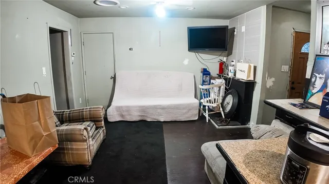 a bedroom with furniture and a flat screen tv