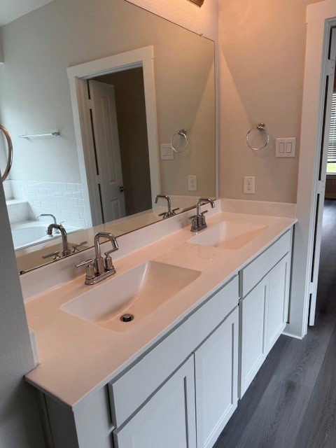 7838 Ruth Ravine Court Spring, TX 77379 - Photo 13 of 23 This photo shows a modern bathroom featuring a dual-sink vanity with sleek fixtures, large mirror, and white cabinetry. The space offers a clean and contemporary feel.