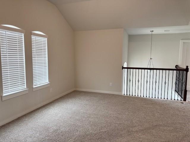 7838 Ruth Ravine Court Spring, TX 77379 - Photo 19 of 23 This photo shows a spacious, carpeted room with vaulted ceilings and two large windows with blinds. It features an open railing overlooking a lower level, adding a modern touch.