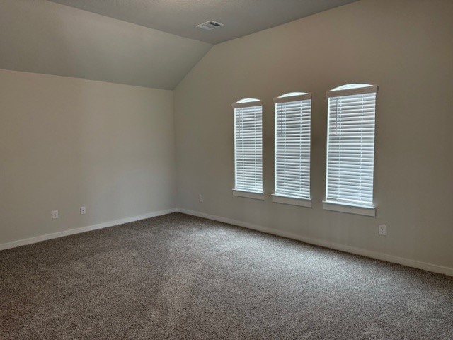 7838 Ruth Ravine Court Spring, TX 77379 - Photo 21 of 23 This room features a spacious area with neutral walls and carpeted floors. Three tall windows with blinds allow for natural light, creating a bright and inviting atmosphere. The high ceiling adds to the room's open feel.