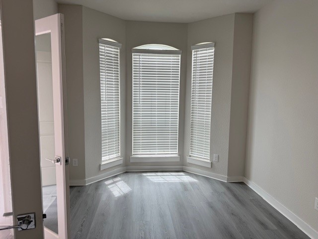 7838 Ruth Ravine Court Spring, TX 77379 - Photo 3 of 23 This room features a bay window with blinds, allowing plenty of natural light. It has light gray hardwood flooring and neutral-colored walls, creating a bright and modern feel.