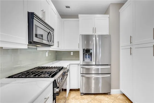 a bathroom with a granite countertop sink mirror vanity and toilet